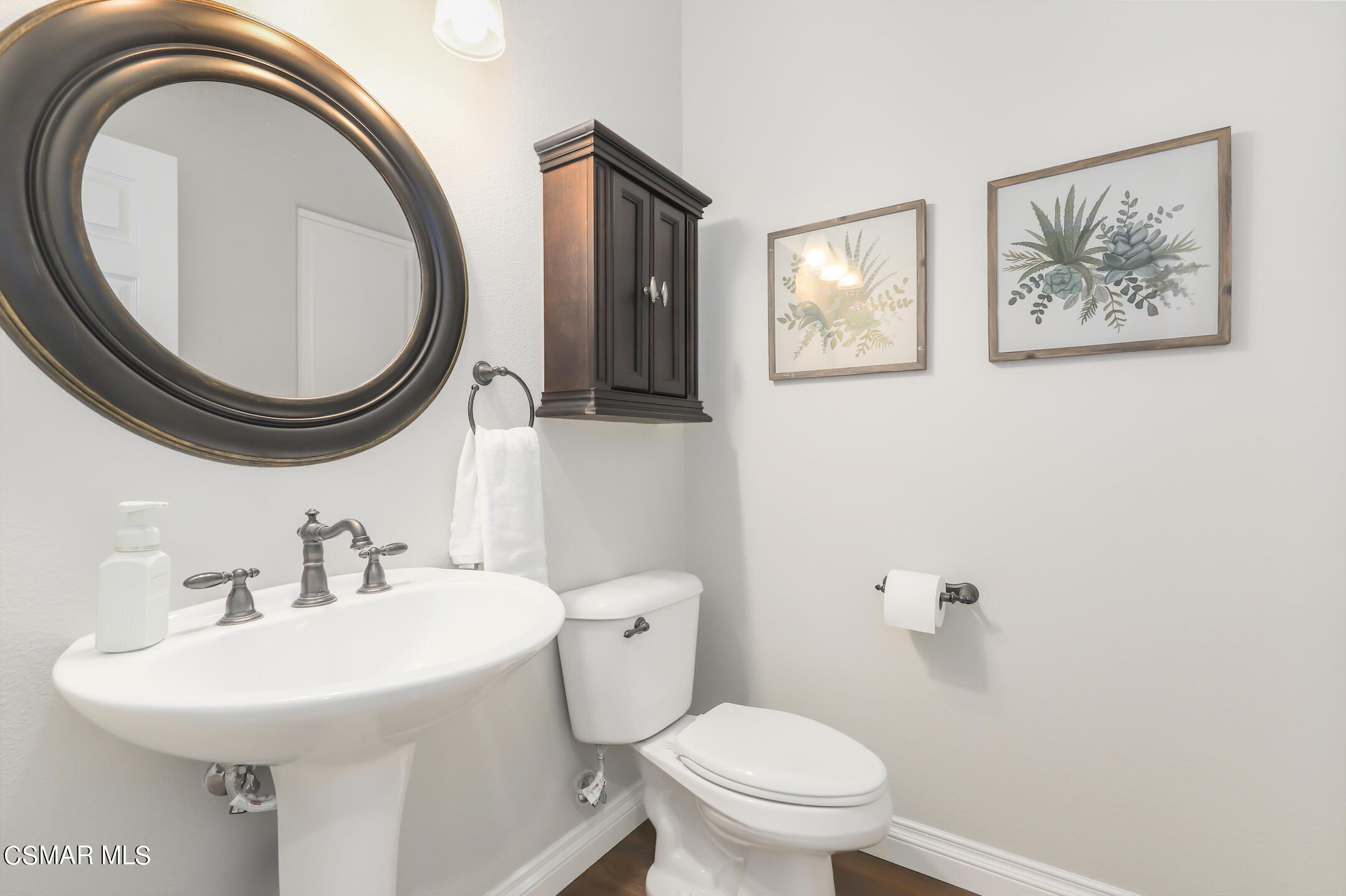 4006 Brindisi Place Moorpark, CA 93021 - Photo 11 of 32 a bathroom with a toilet a sink and a mirror