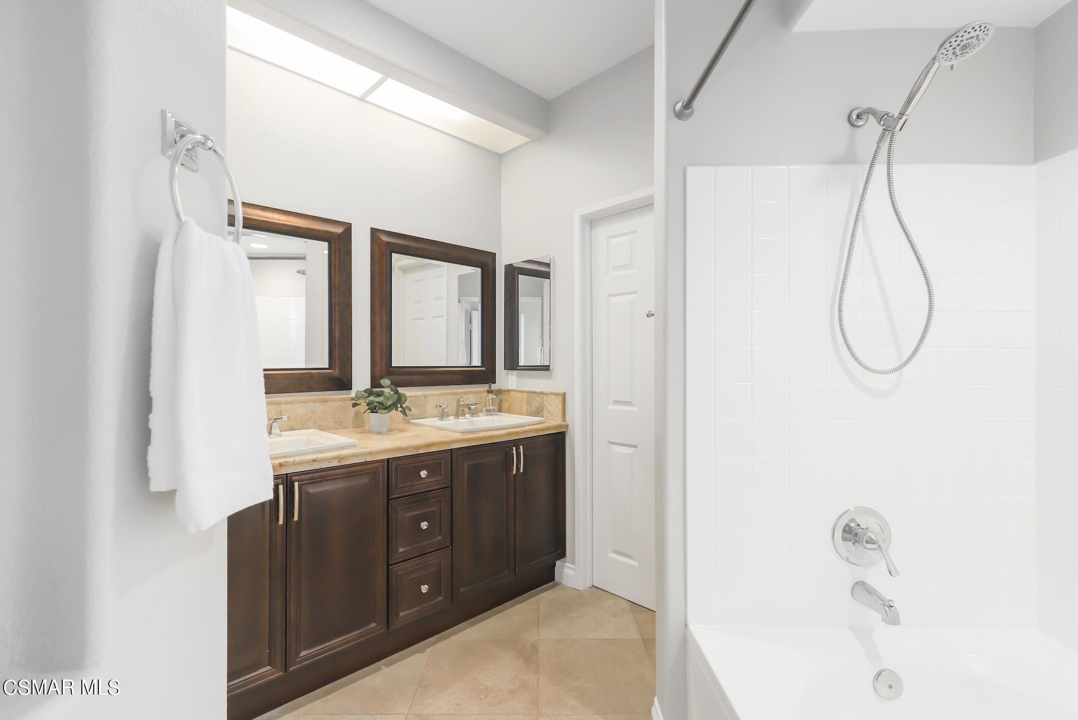 4006 Brindisi Place Moorpark, CA 93021 - Photo 18 of 32 a bathroom with a granite countertop sink a mirror and a shower