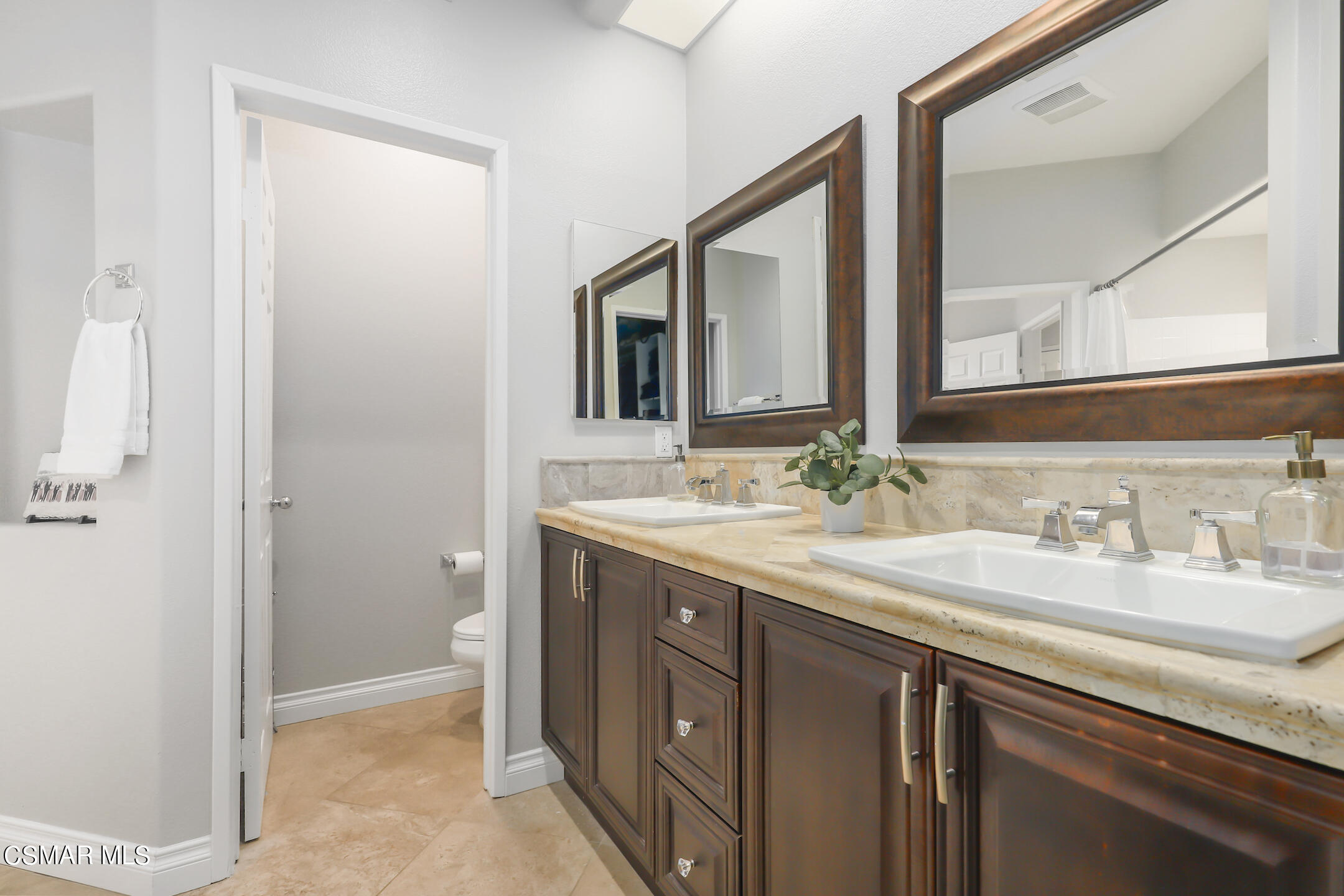 4006 Brindisi Place Moorpark, CA 93021 - Photo 19 of 32 a bathroom with a double vanity sink and mirror