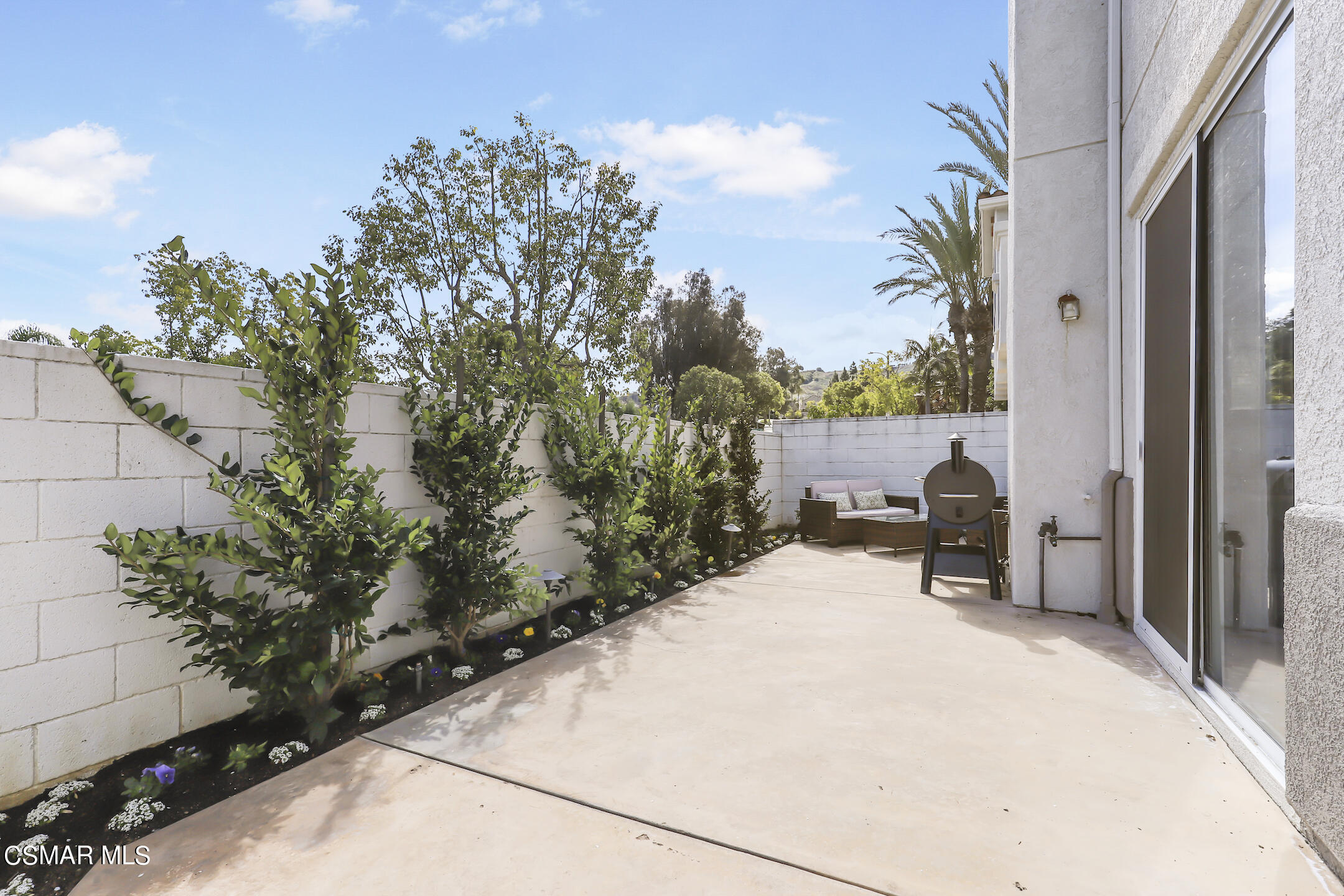 4006 Brindisi Place Moorpark, CA 93021 - Photo 23 of 32 a balcony with table and chairs and potted plants