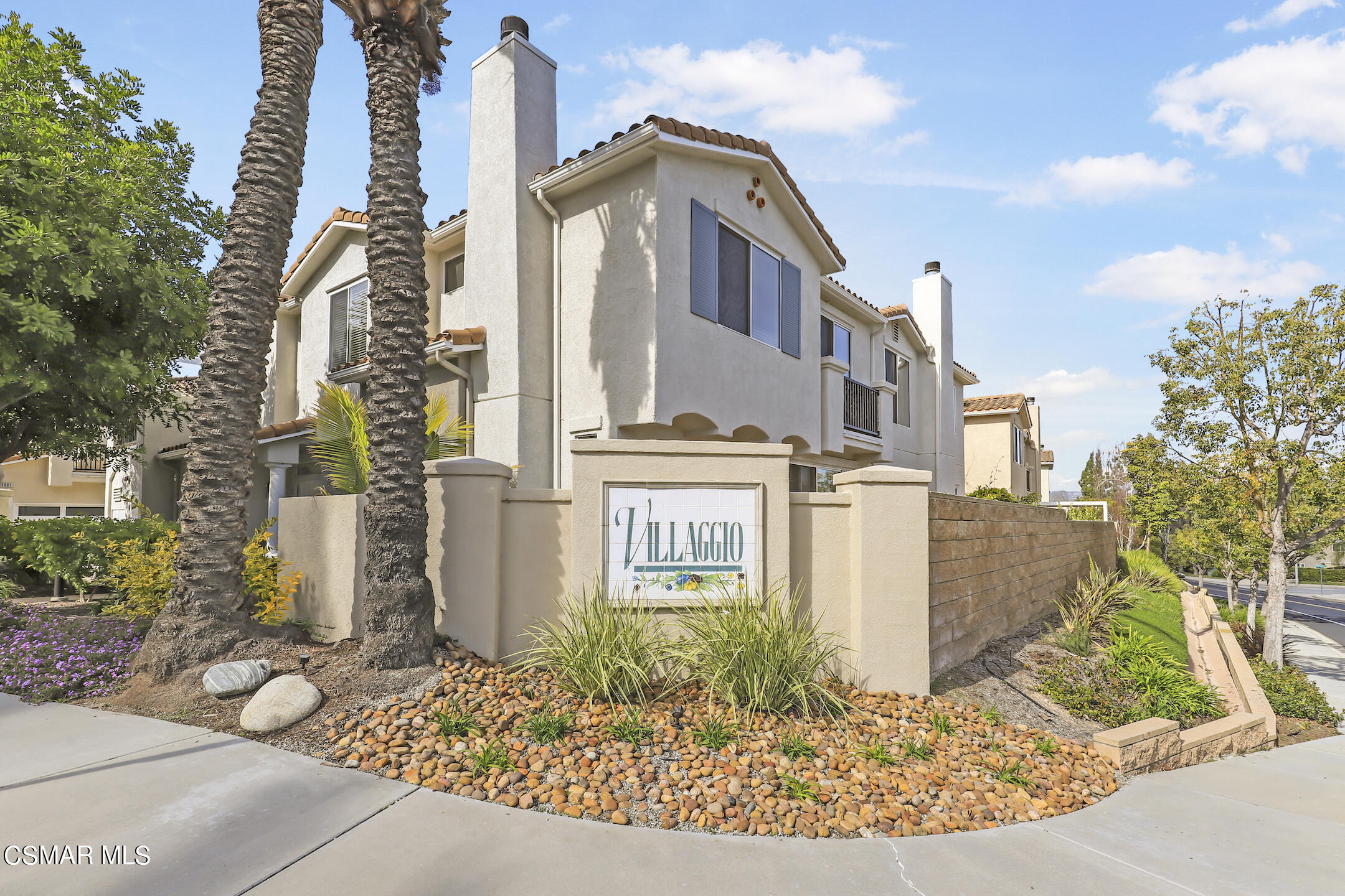 4006 Brindisi Place Moorpark, CA 93021 - Photo 29 of 32 a front view of a residential apartment building with a yard