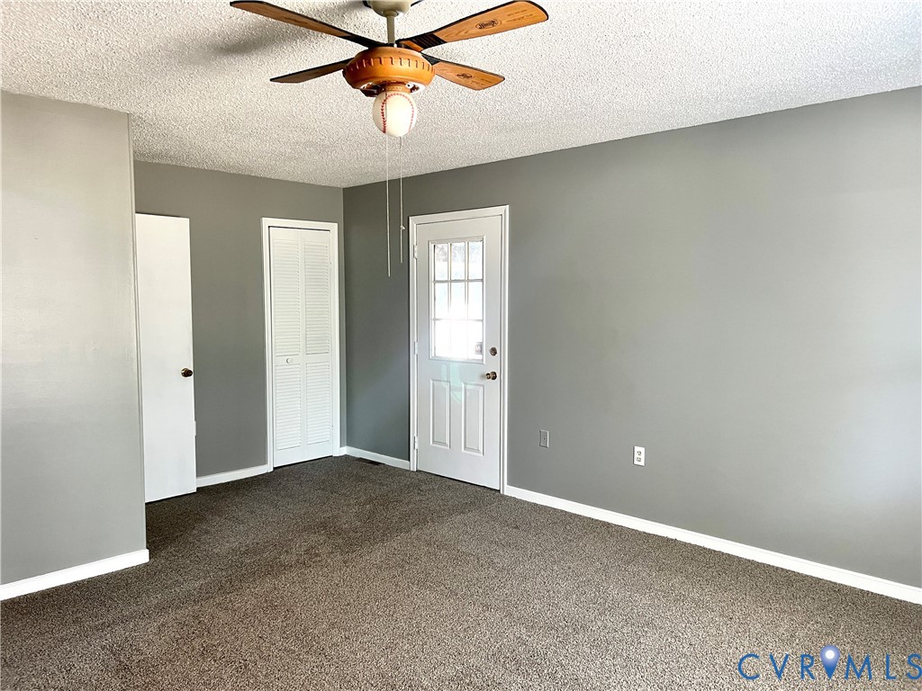 2049 Riddle Road Blackstone, VA 23824 - Photo 14 of 44 Unfurnished bedroom with dark carpet, a textured c