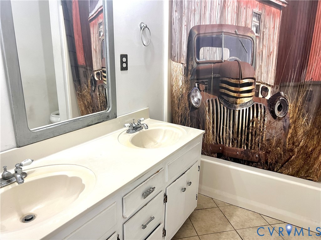 2049 Riddle Road Blackstone, VA 23824 - Photo 15 of 44 Full bathroom with double vanity and light tile pa