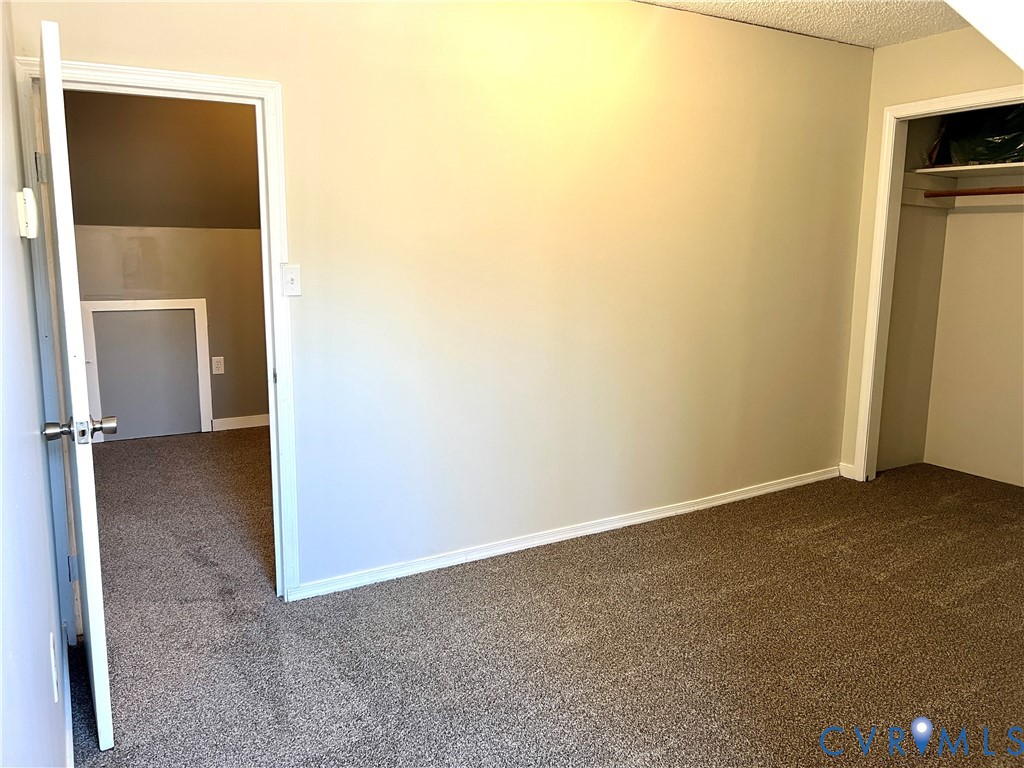 2049 Riddle Road Blackstone, VA 23824 - Photo 26 of 44 Unfurnished bedroom featuring dark carpet, a close
