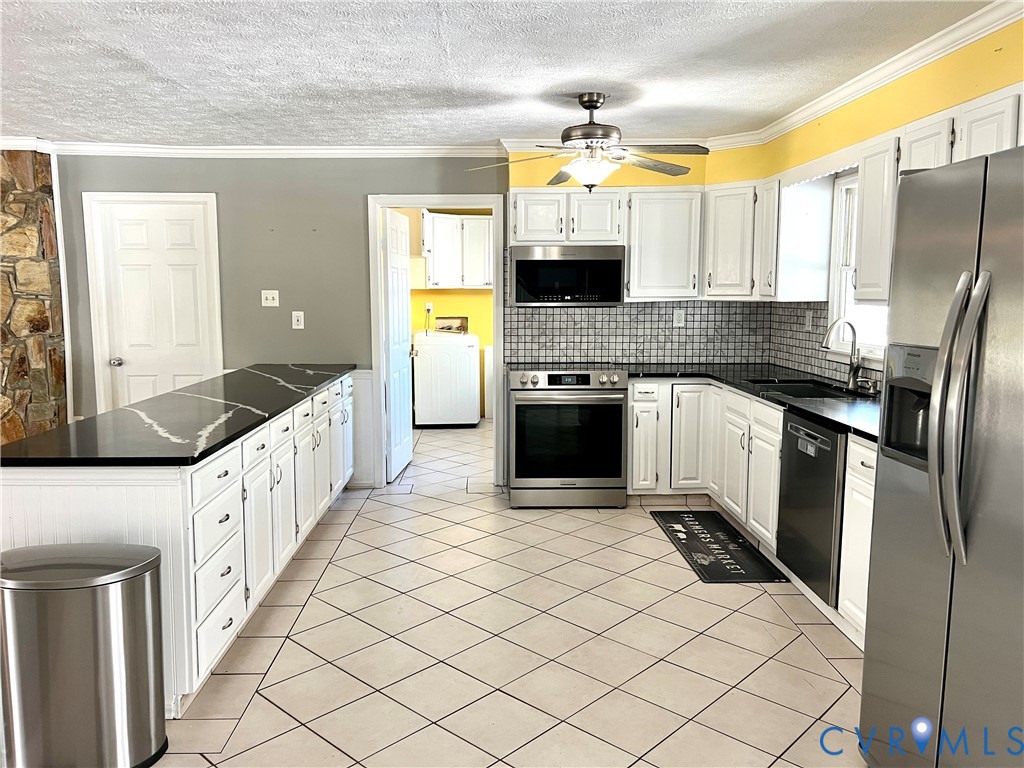 2049 Riddle Road Blackstone, VA 23824 - Photo 7 of 44 Kitchen with white cabinets, stainless steel appli