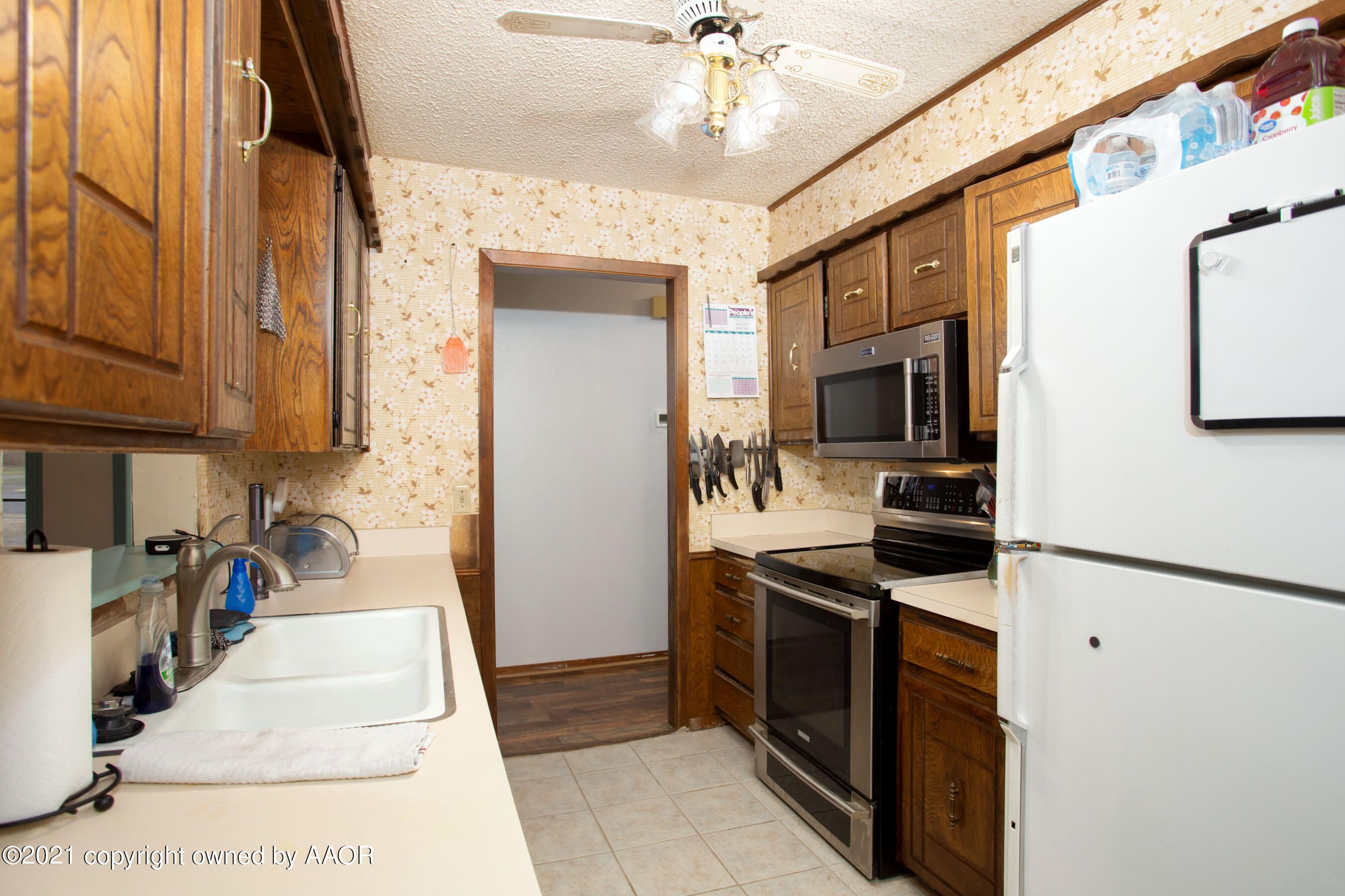 5306 South Fannin Street Amarillo, TX 79110 - Photo 6 of 18 a kitchen with stainless steel appliances granite countertop a stove top oven a sink a counter space and cabinets