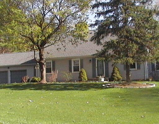 8 Lantern Drive Ridgefield, CT 06877 - Photo 1 of 1 a front view of house with yard and green space