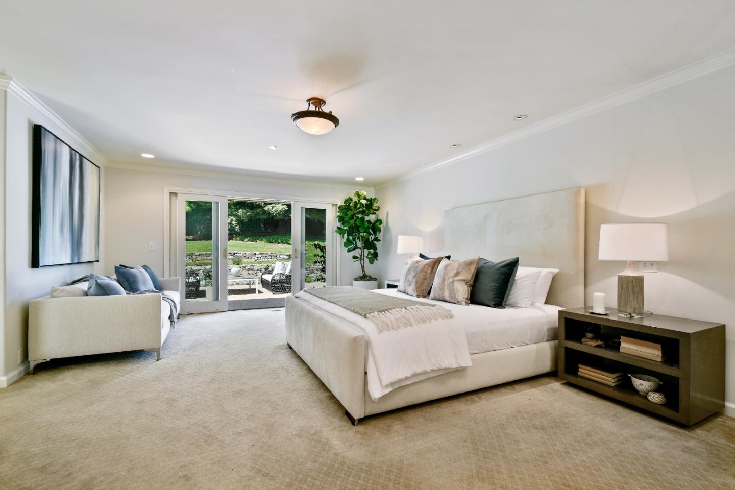 855 Longview Road Hillsborough, CA 94010 - Photo 19 of 32 a spacious bedroom with a bed and a couch
