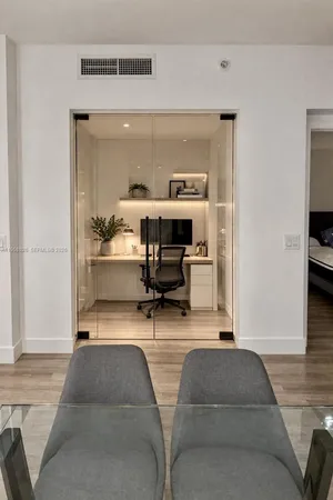 a living room with furniture a table and chairs