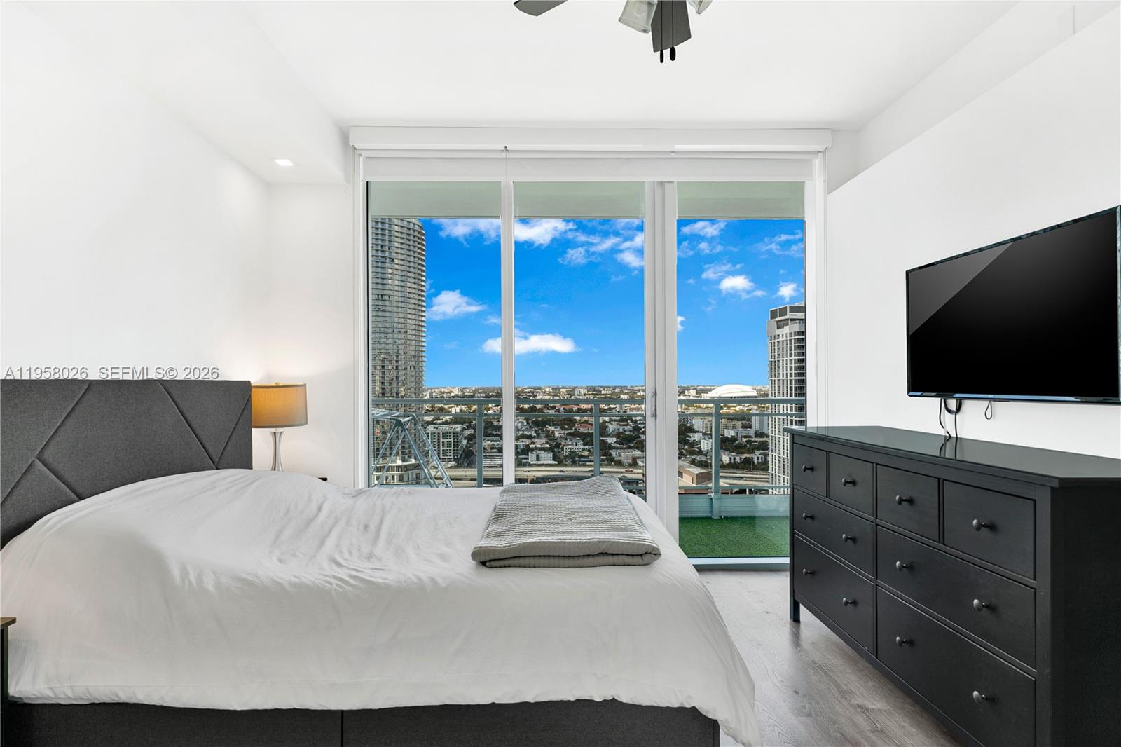 92 Southwest 3rd Street, Unit 3108 Miami, FL 33130 - Photo 12 of 18 a living room with furniture and a flat screen tv