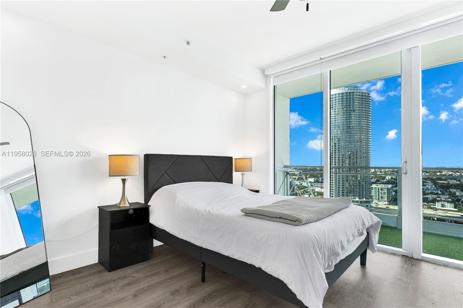 92 Southwest 3rd Street, Unit 3108 Miami, FL 33130 - Photo 13 of 18 a bedroom with a bed and a large window