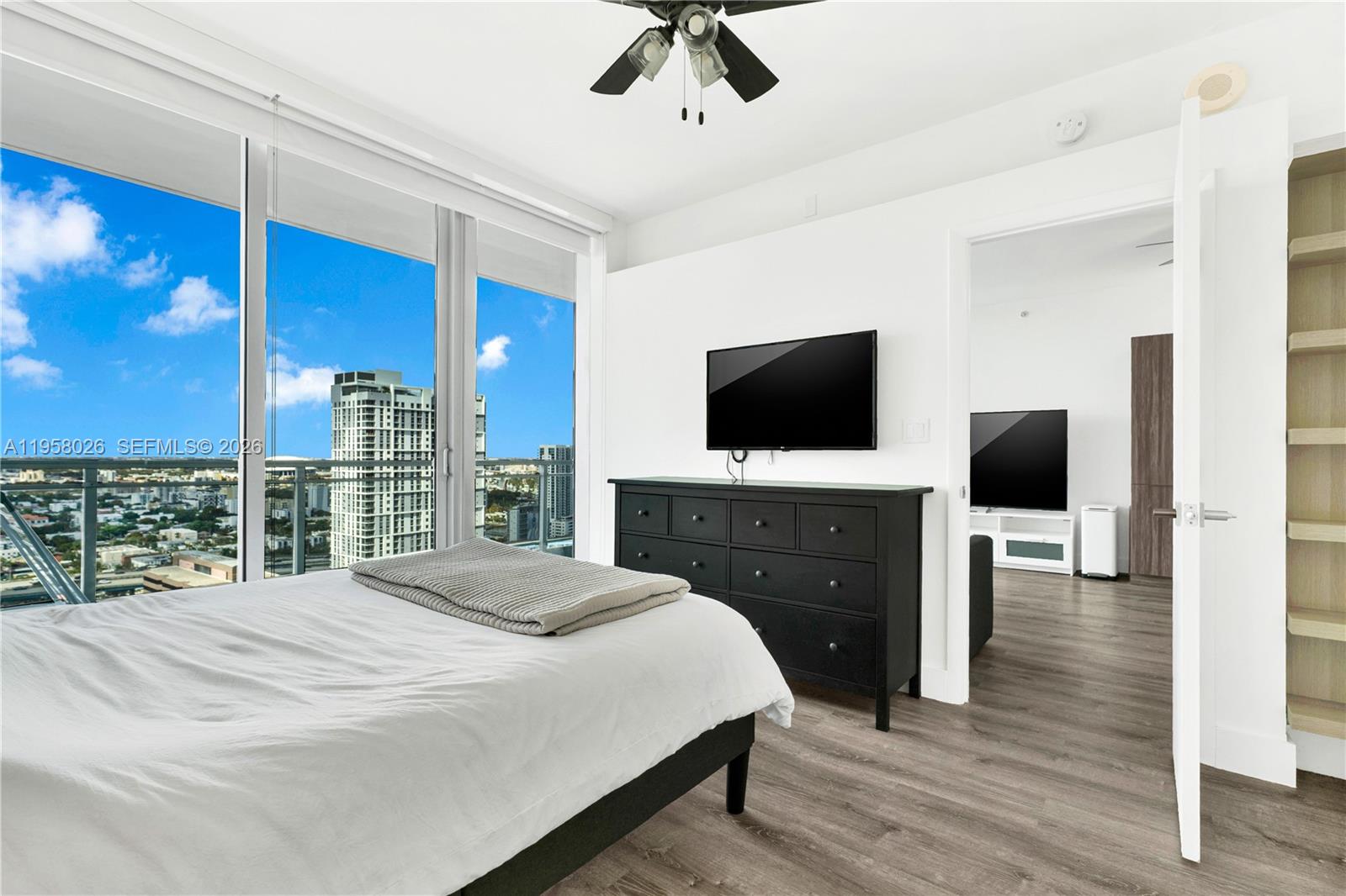 92 Southwest 3rd Street, Unit 3108 Miami, FL 33130 - Photo 14 of 18 a bedroom with a bed and a flat screen tv