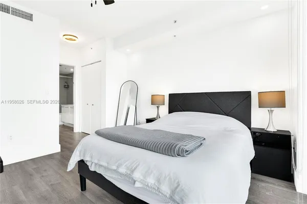 a bedroom with a bed and a night stand