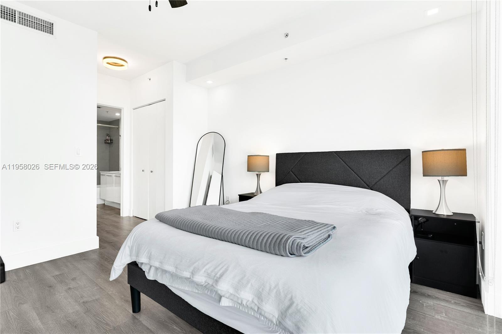 92 Southwest 3rd Street, Unit 3108 Miami, FL 33130 - Photo 15 of 18 a bedroom with a bed and a night stand