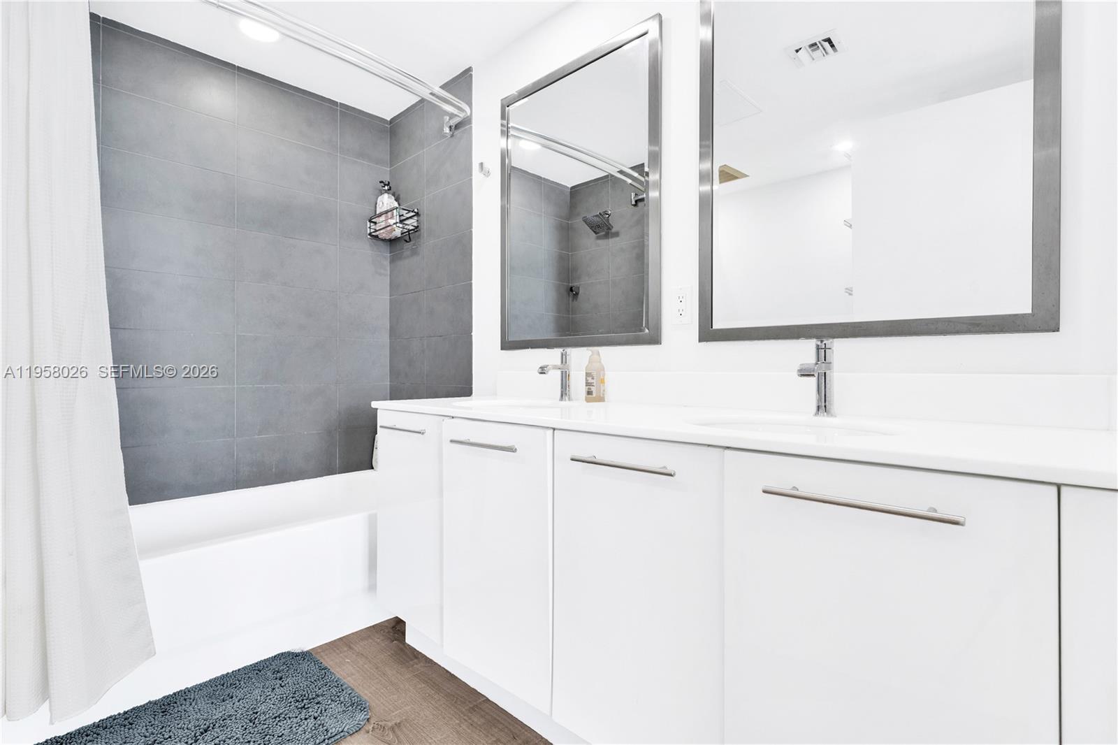 92 Southwest 3rd Street, Unit 3108 Miami, FL 33130 - Photo 16 of 18 a bathroom with a sink a toilet a mirror and shower
