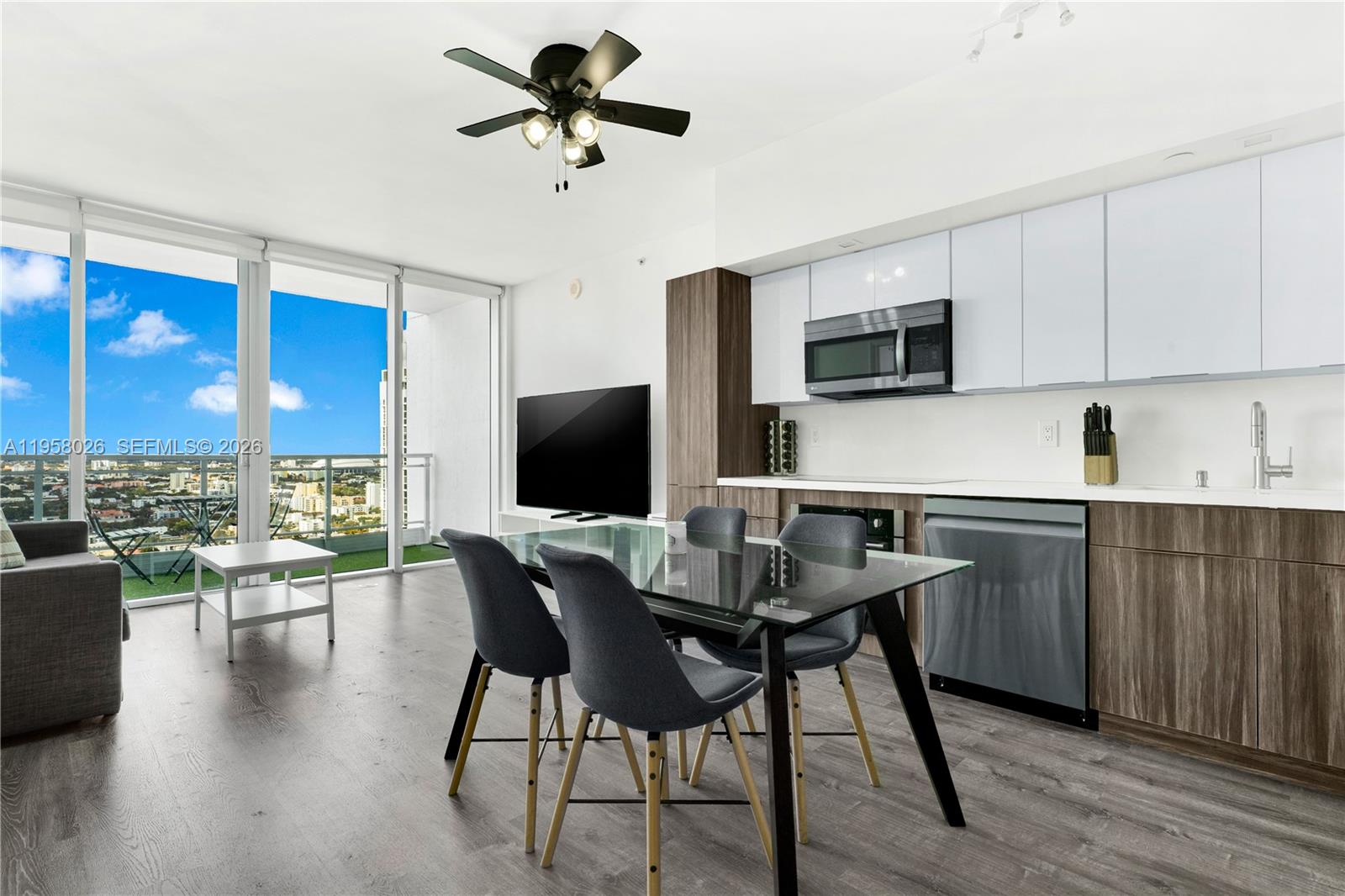 92 Southwest 3rd Street, Unit 3108 Miami, FL 33130 - Photo 4 of 19 a kitchen with a table chairs refrigerator and microwave