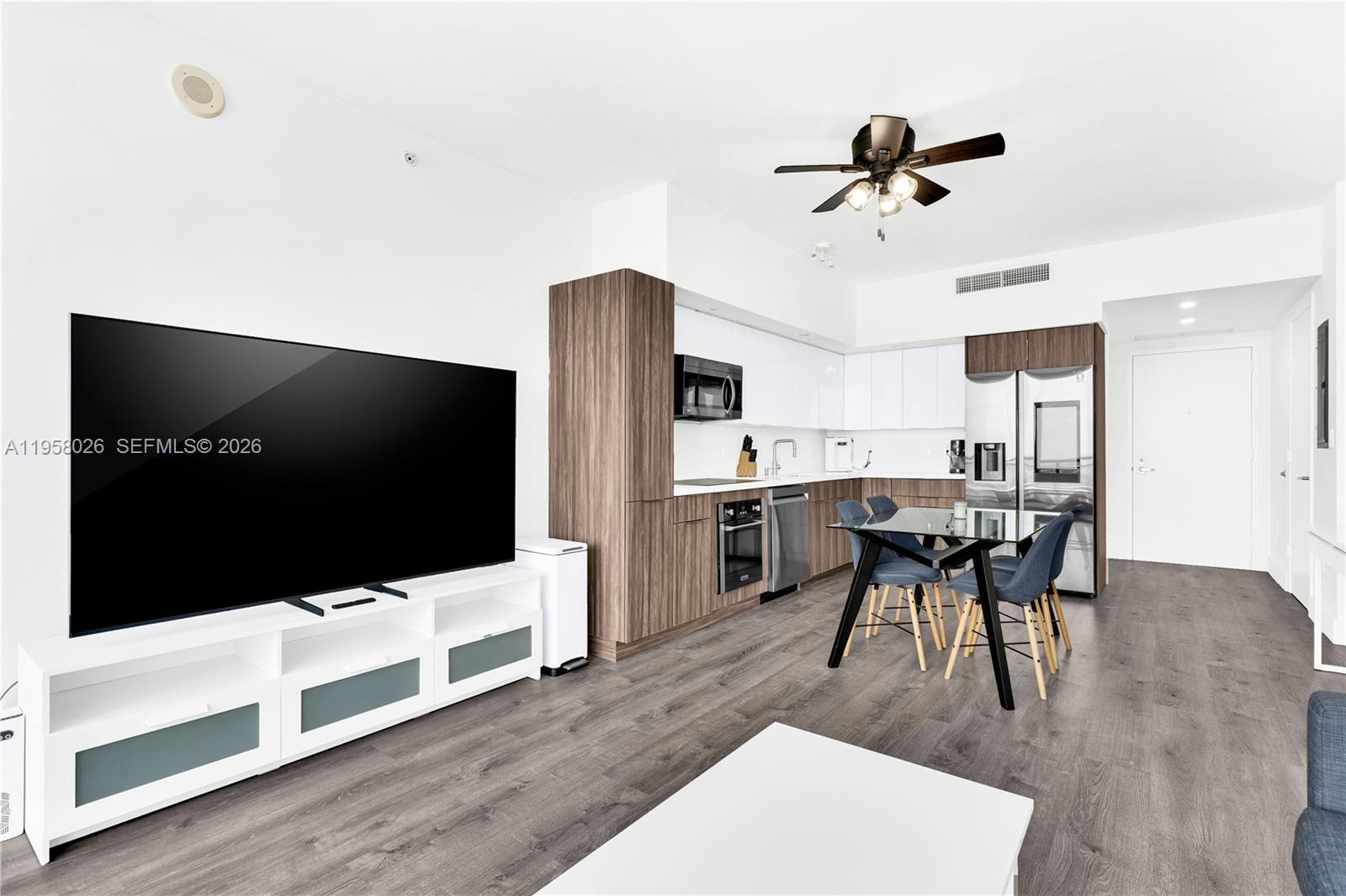 92 Southwest 3rd Street, Unit 3108 Miami, FL 33130 - Photo 7 of 19 a living room with stainless steel appliances kitchen island furniture and wooden floor