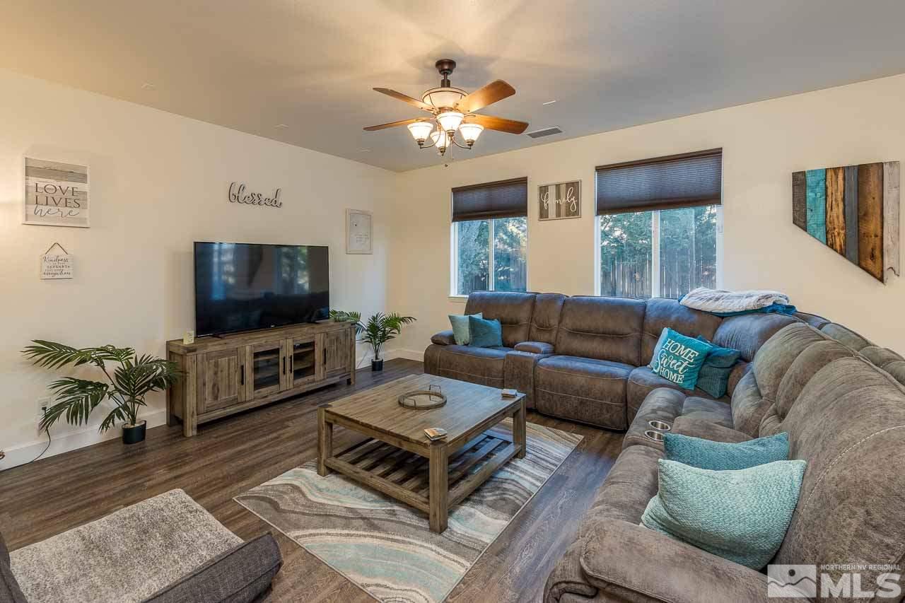 9150 Sunrock Road Reno, NV 89521 - Photo 4 of 19 a living room with furniture a flat screen tv and a chandelier