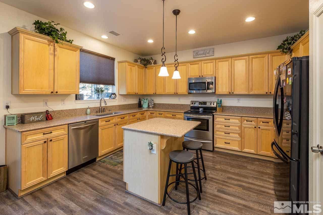9150 Sunrock Road Reno, NV 89521 - Photo 8 of 19 a kitchen with a sink a counter top space stainless steel appliances and cabinets