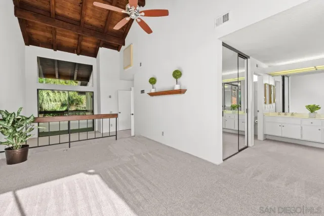 a view of a living room and a balcony