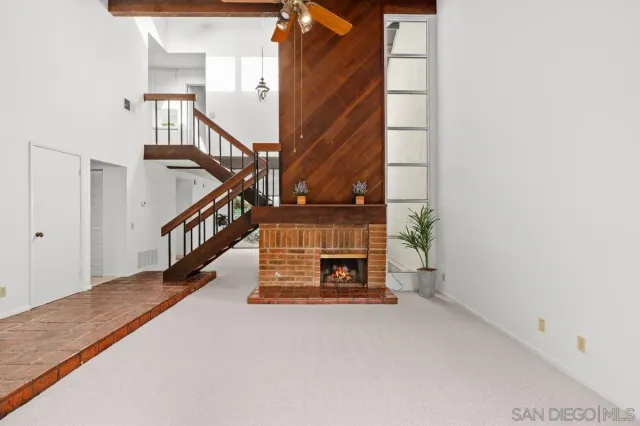a view of staircase with white walls and a window