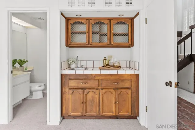 a bathroom with a sink a toilet and a mirror