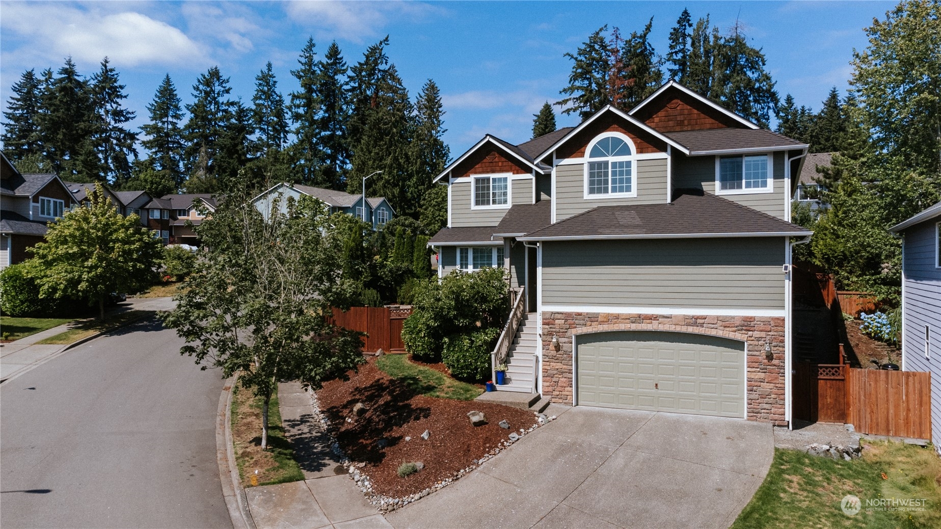 2115 241st Street Southwest Bothell, WA 98021 - Photo 1 of 40 a front view of a house with a garden