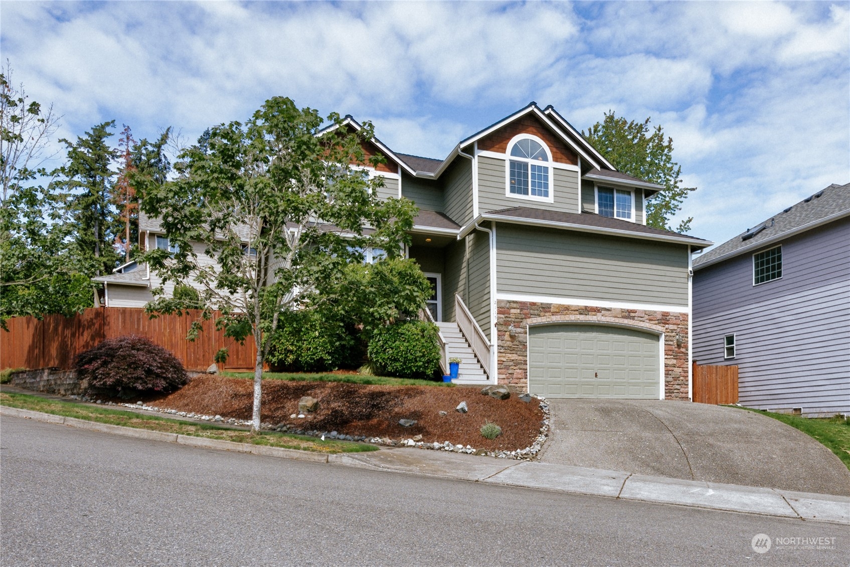 2115 241st Street Southwest Bothell, WA 98021 - Photo 3 of 40 a front view of a house with a yard and garage