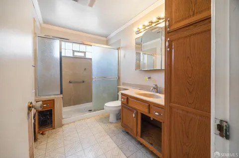 a spacious bathroom with a sink a toilet and shower