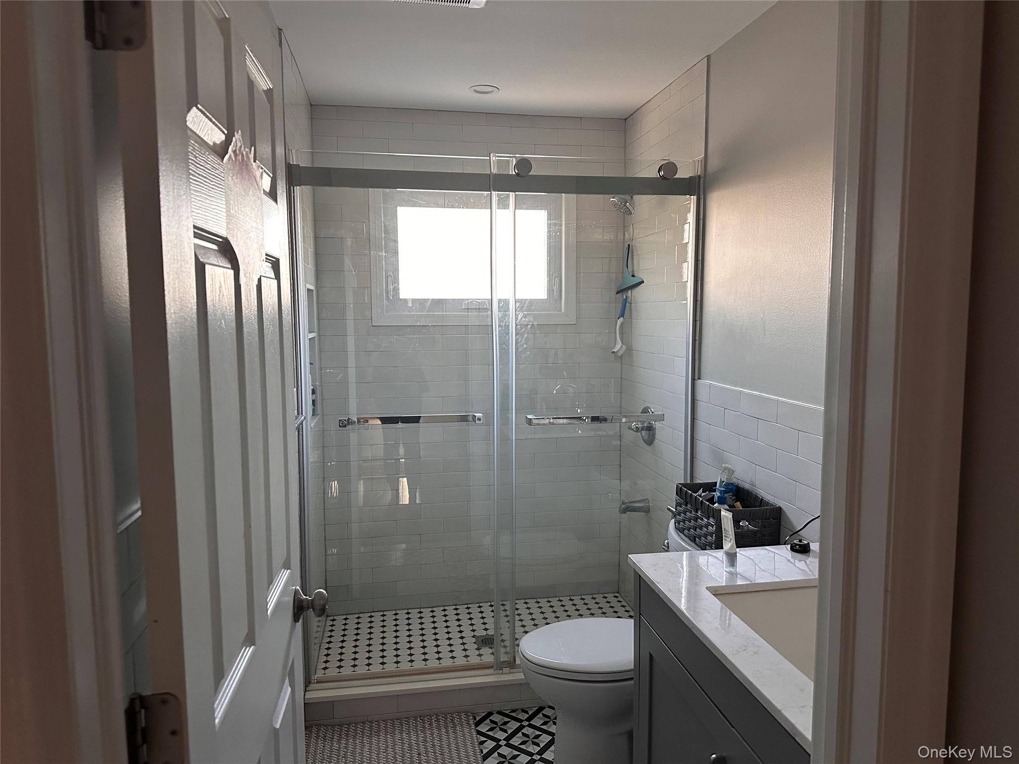 84 Commonwealth Avenue Merrick, NY 11566 - Photo 4 of 6 a bathroom with a sink toilet and shower