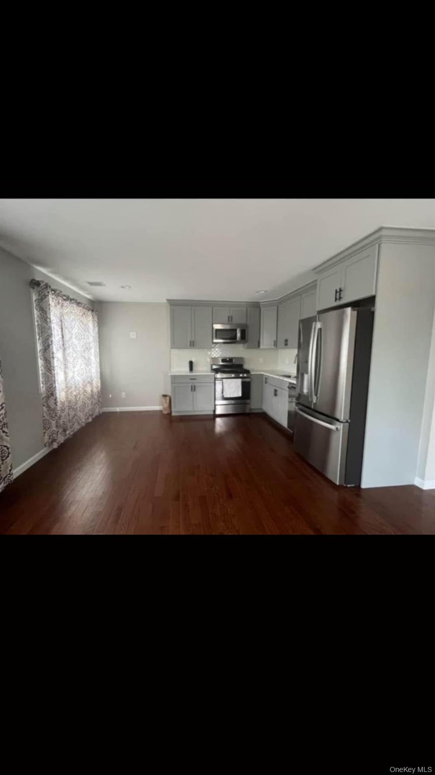 84 Commonwealth Avenue Merrick, NY 11566 - Photo 5 of 6 a kitchen with sink and refrigerator