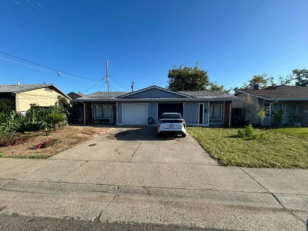 a front view of a house with a garden