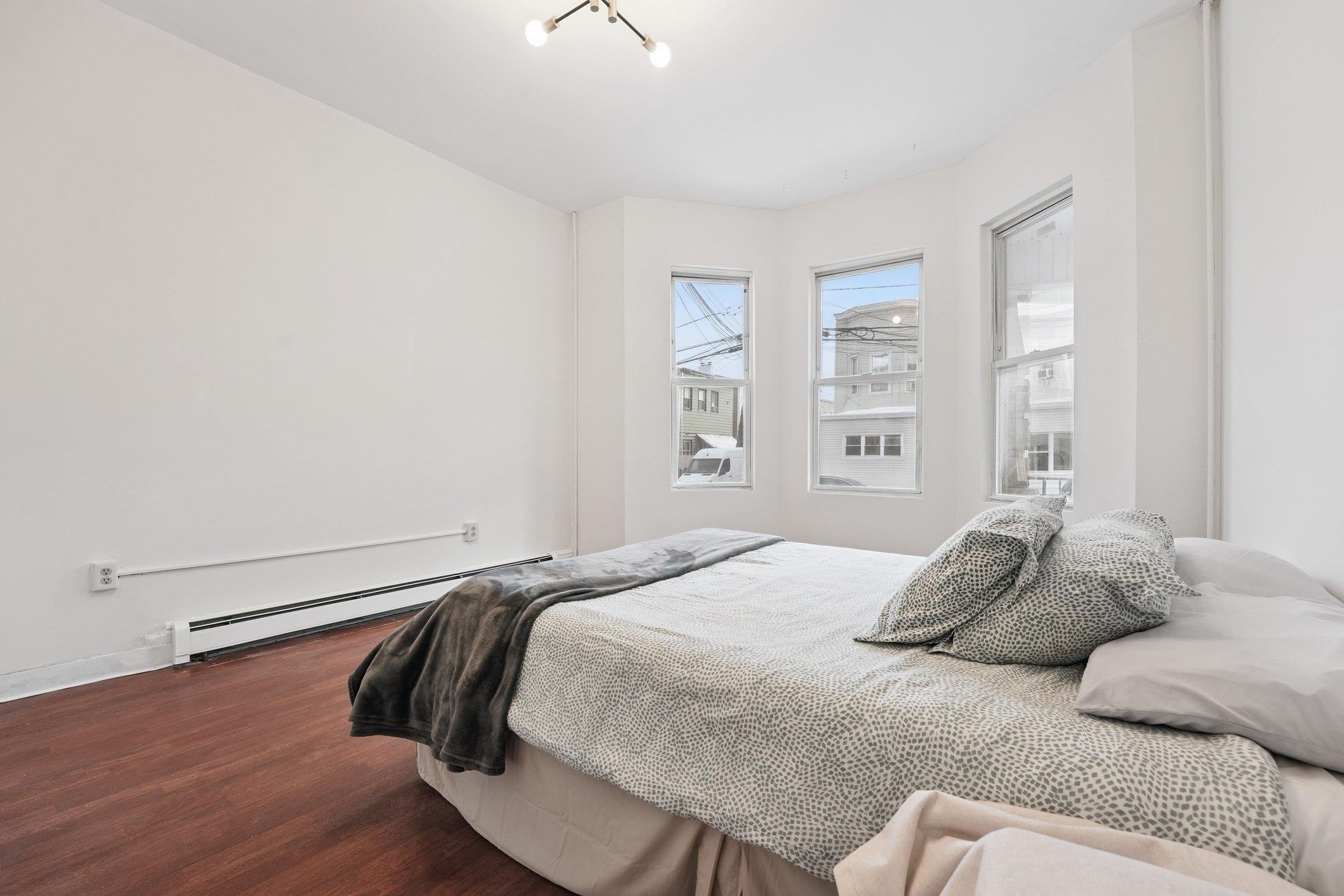 910 19th Street Union City, NJ 07087 - Photo 20 of 30 a bedroom with a bed and a window