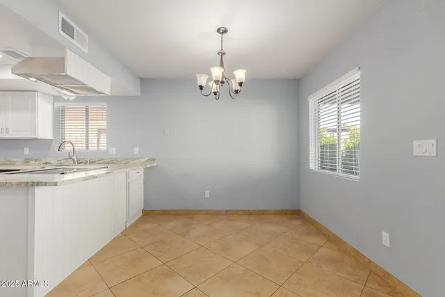 a bathroom with a granite countertop sink a large mirror and a bathtub