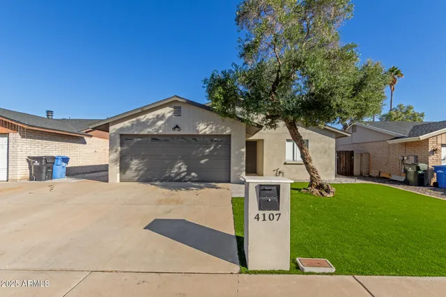 a front view of a house with yard and garage