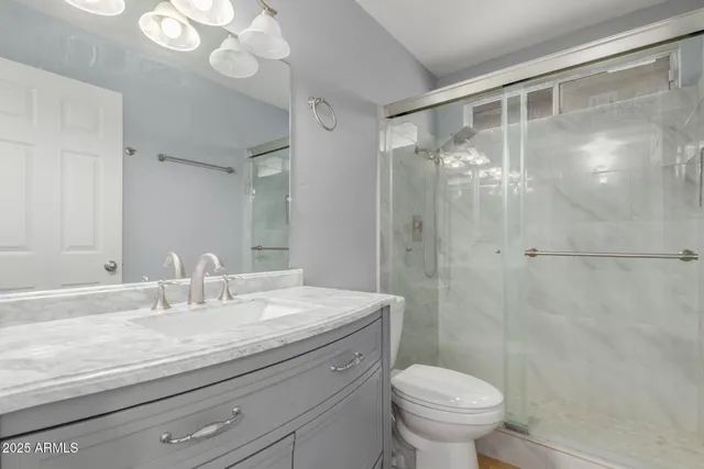 a bathroom with a sink toilet and shower