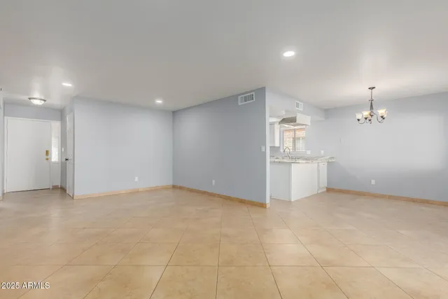 a view of an empty room with a kitchen