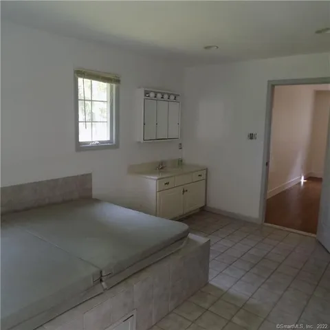 a room with a bed and cabinets