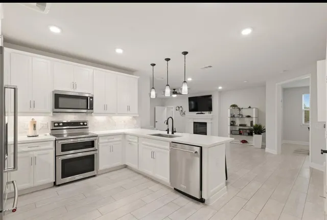 a living room with furniture a fireplace and a flat screen tv