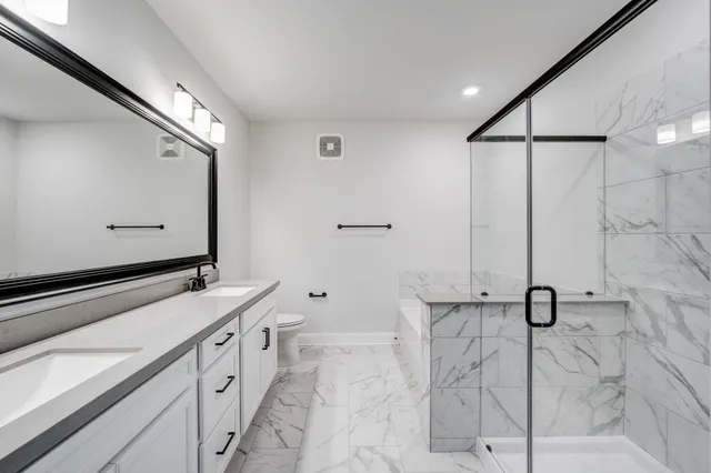 an aerial view of a house with a swimming pool and outdoor seating