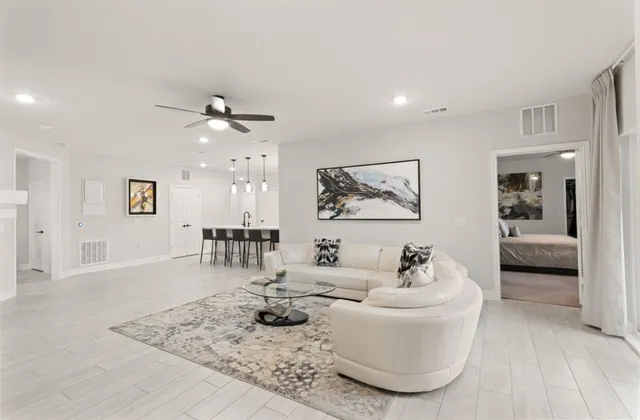 a bedroom with a large bed and a ceiling fan
