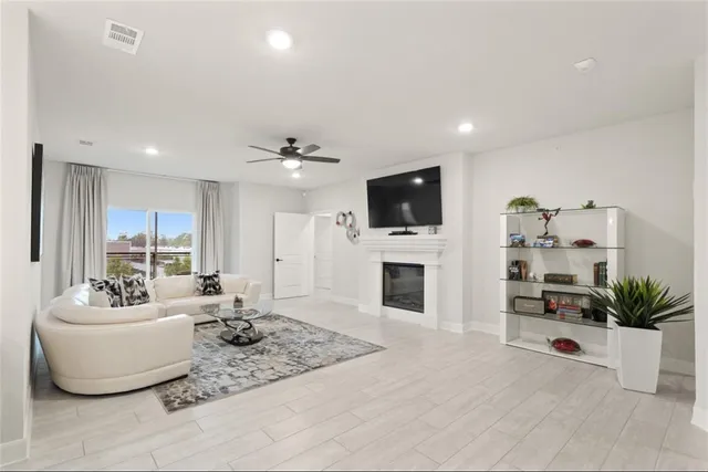 a bedroom with a large bed and a ceiling fan