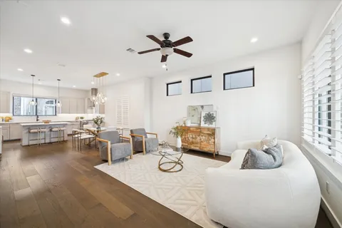 a living room with furniture and kitchen view