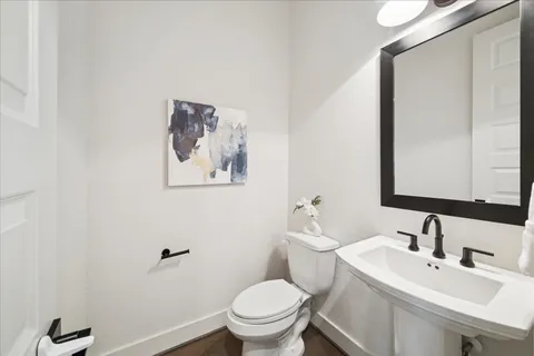 a bathroom with a toilet sink and mirror