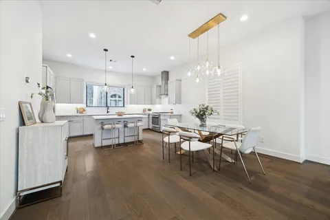 a large kitchen with a table and chairs