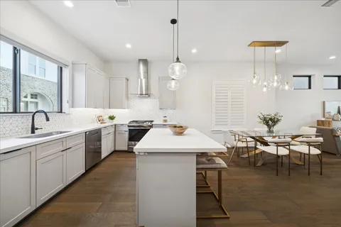 a kitchen with a table chairs sink and cabinets