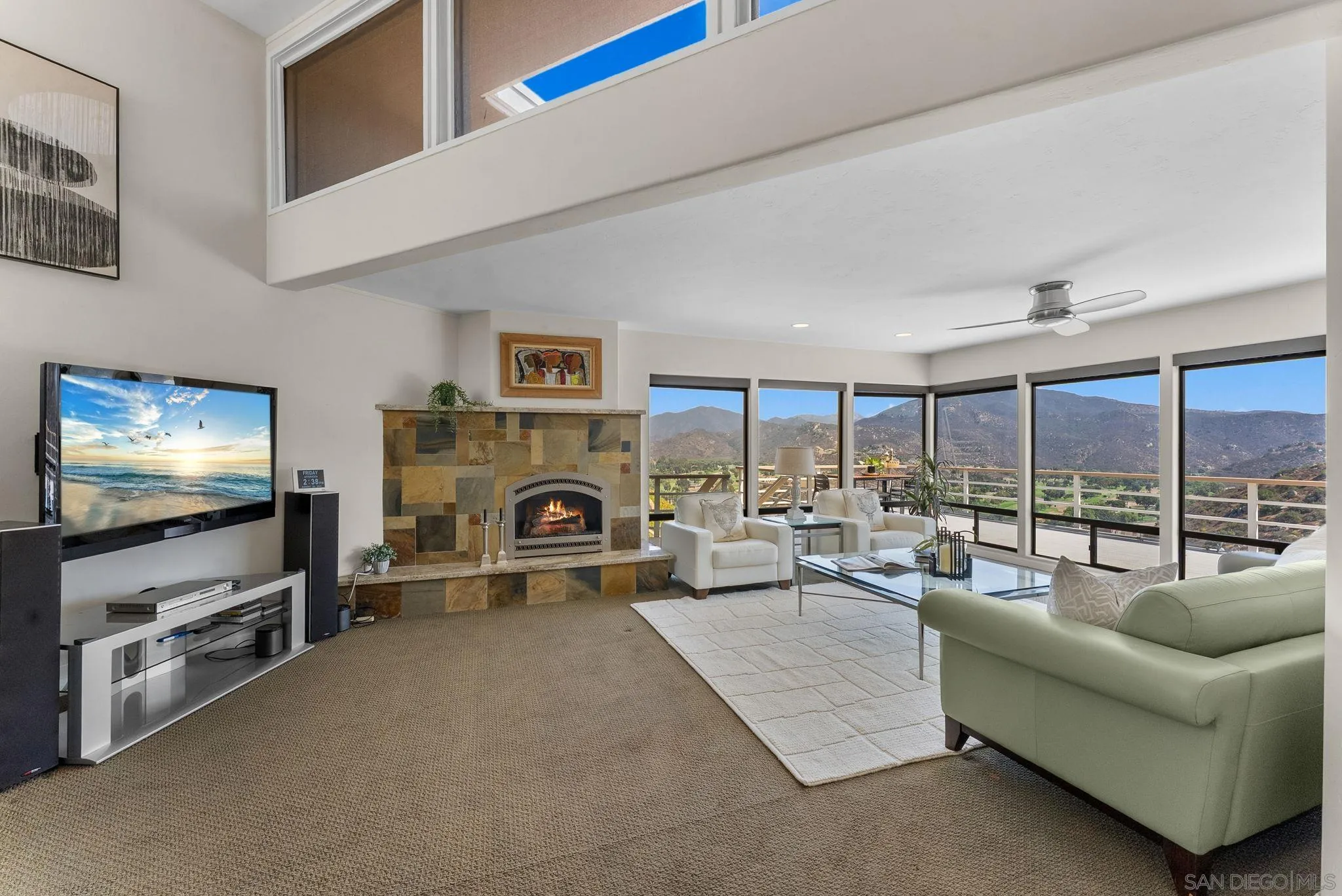 2552 Singing Vista Way El Cajon, CA 92019 - Photo 12 of 34 a living room with furniture a flat screen tv and a fireplace