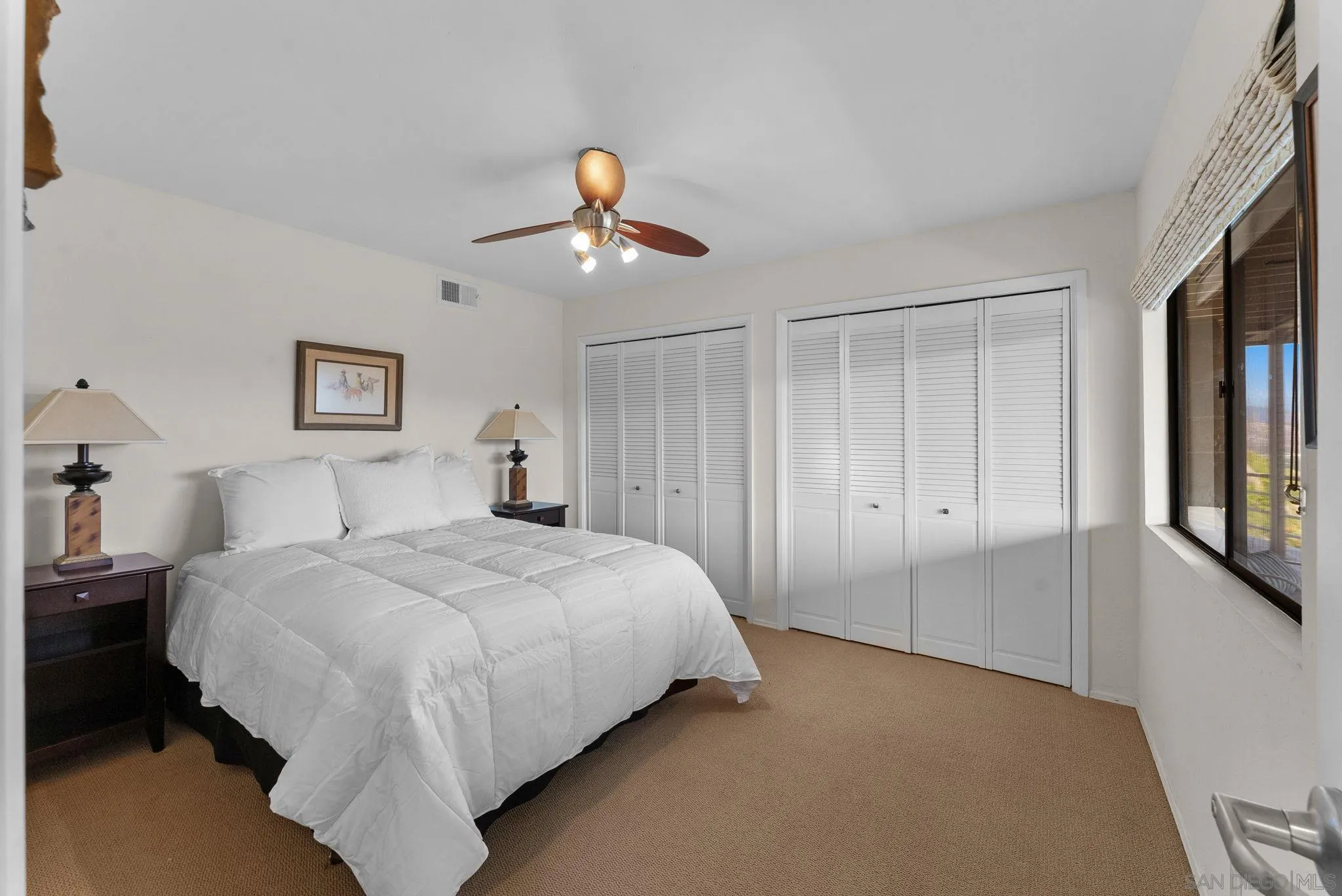 2552 Singing Vista Way El Cajon, CA 92019 - Photo 18 of 34 a bedroom with a large bed and a chandelier