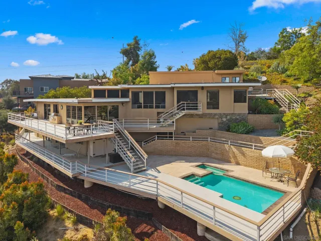 a house with swimming pool in front of it