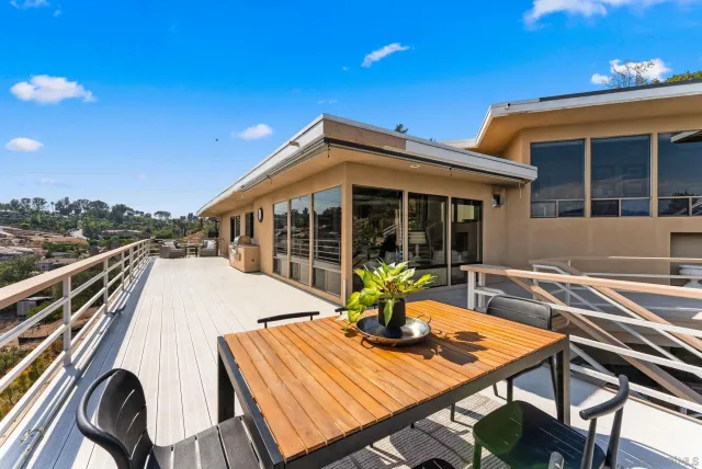 a view of a house with pool and sitting area